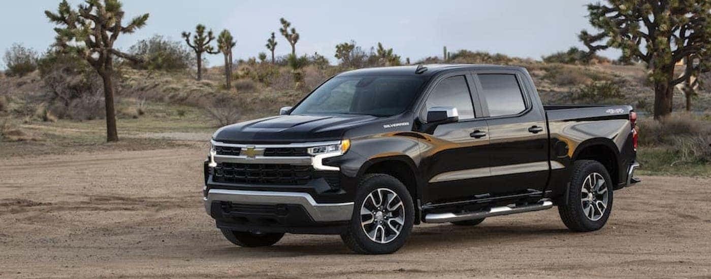 A black 2022 Chevy Silverado 1500 LT is shown from the side.