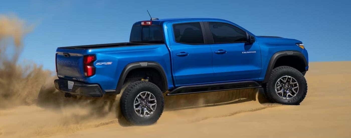A blue 2024 Chevy Colorado ZR2 is shown off-roading.
