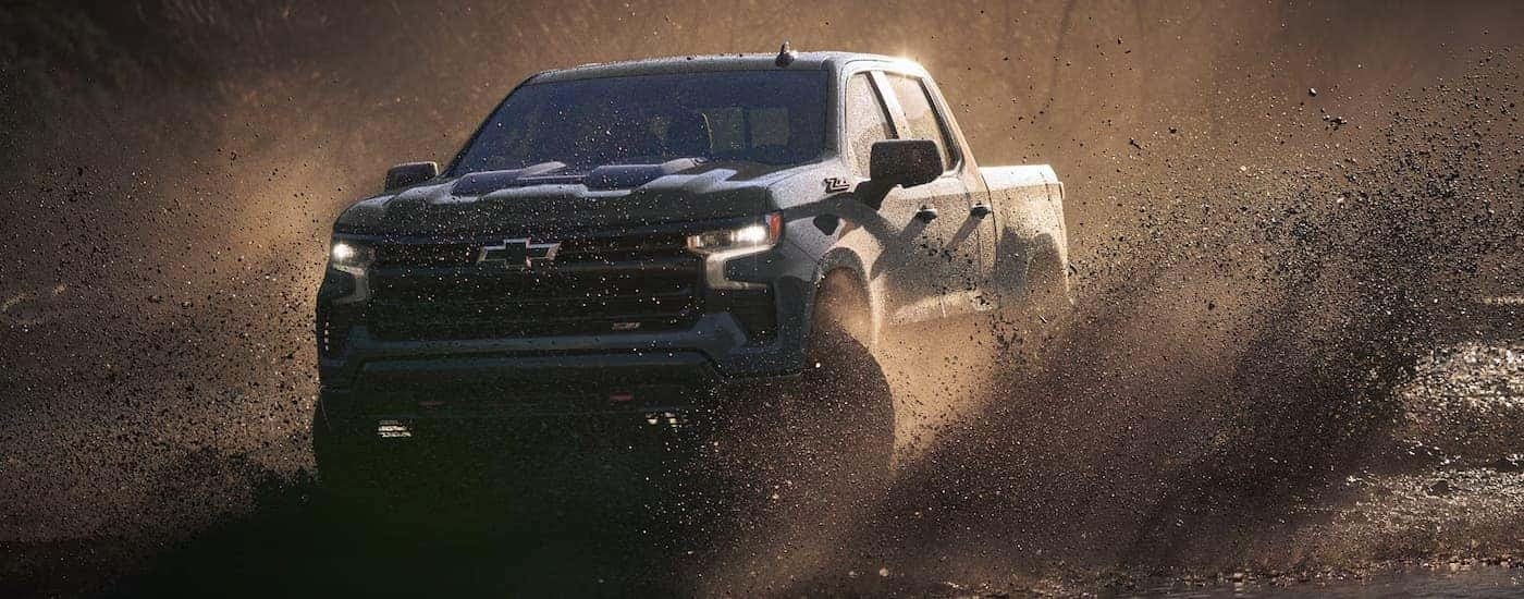Grey 2026 Chevy Silverado 1500 ZR2 off-roading through mud