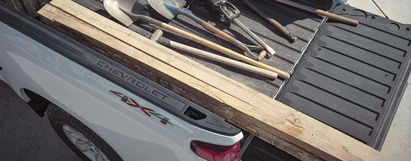 Tools in the bed of a white 2026 Chevy Silverado 1500