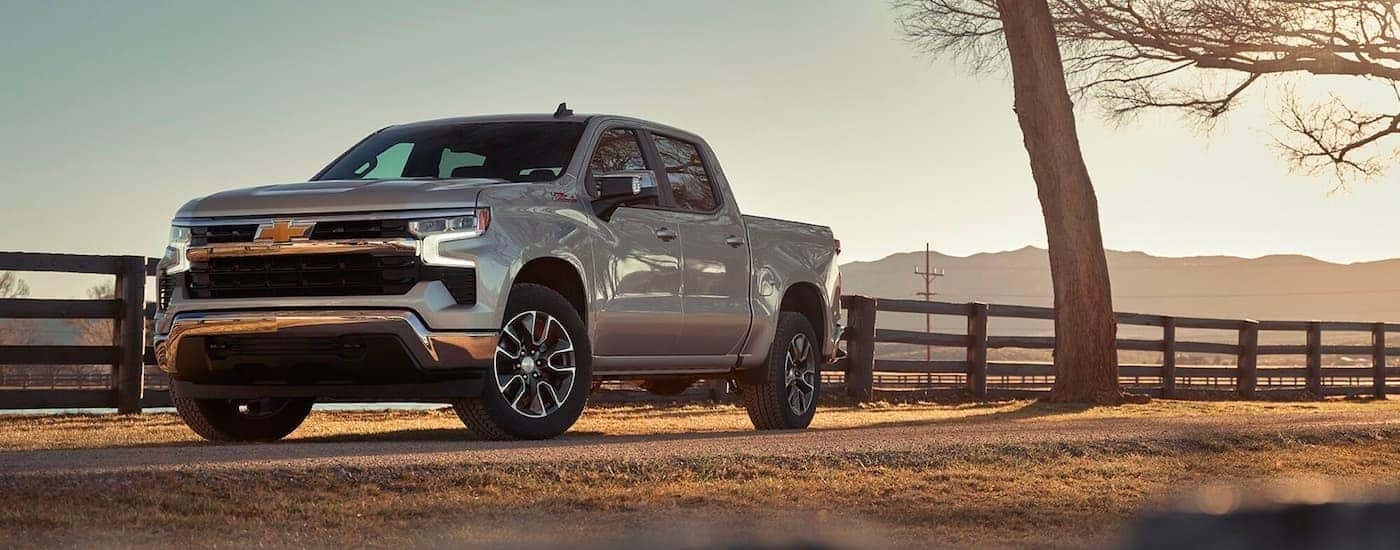 A silver 2024 Chevy Silverado 1500 LT Z71 is shown parked after viewing a Chevy Silverado 1500 for s…
