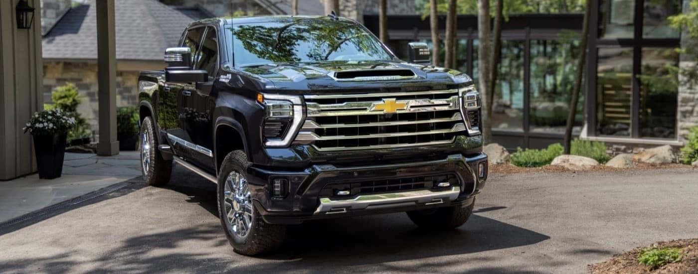 A black 2024 Chevy Silverado 2500 HD for sale is shown from the front at an angle.